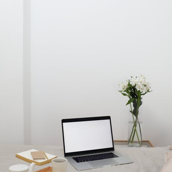 A cozy corner in a home with a cup of tea and a notebook.