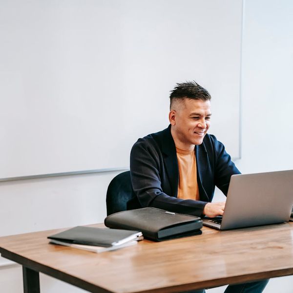 Person sitting at a desk looking focused and relaxed.